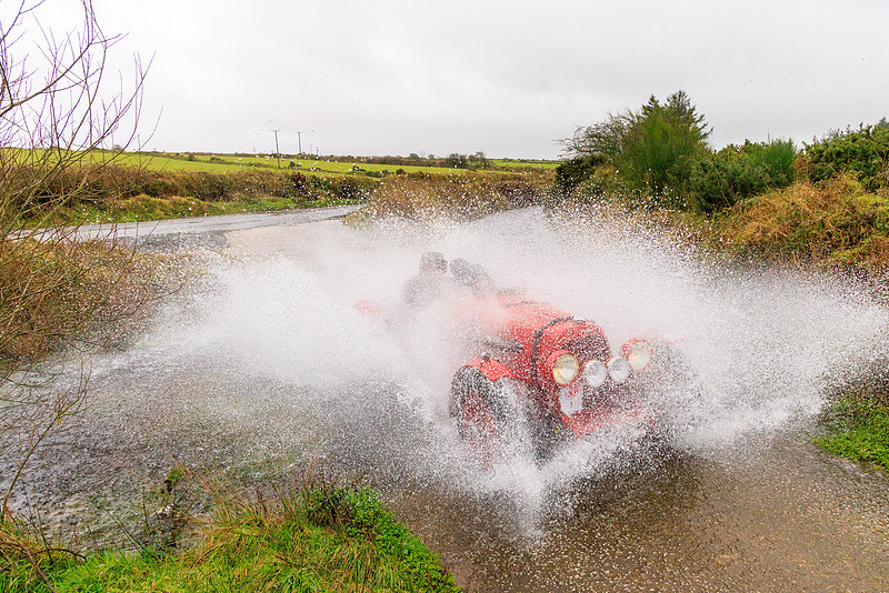 Simon Arscott/Emily Anderson in an Aston Martin Speed Model 2L on the first morning splashing through a ford on Bodmin Moor, Cornwall, UK